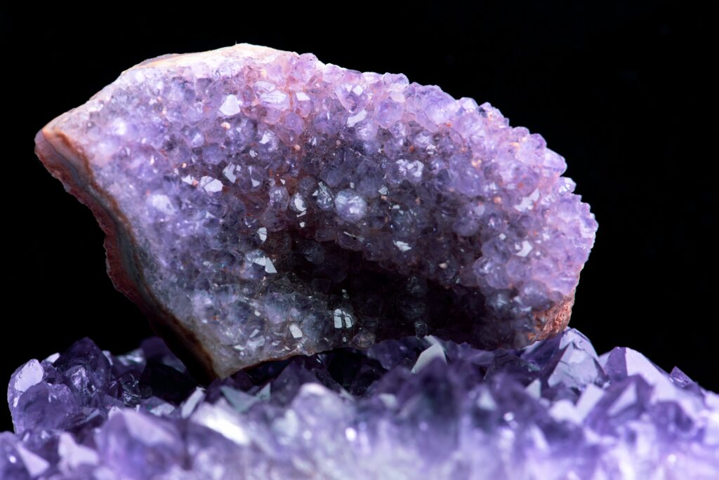 Close-up of a stunning purple amethyst geode showcasing natural crystal formations.